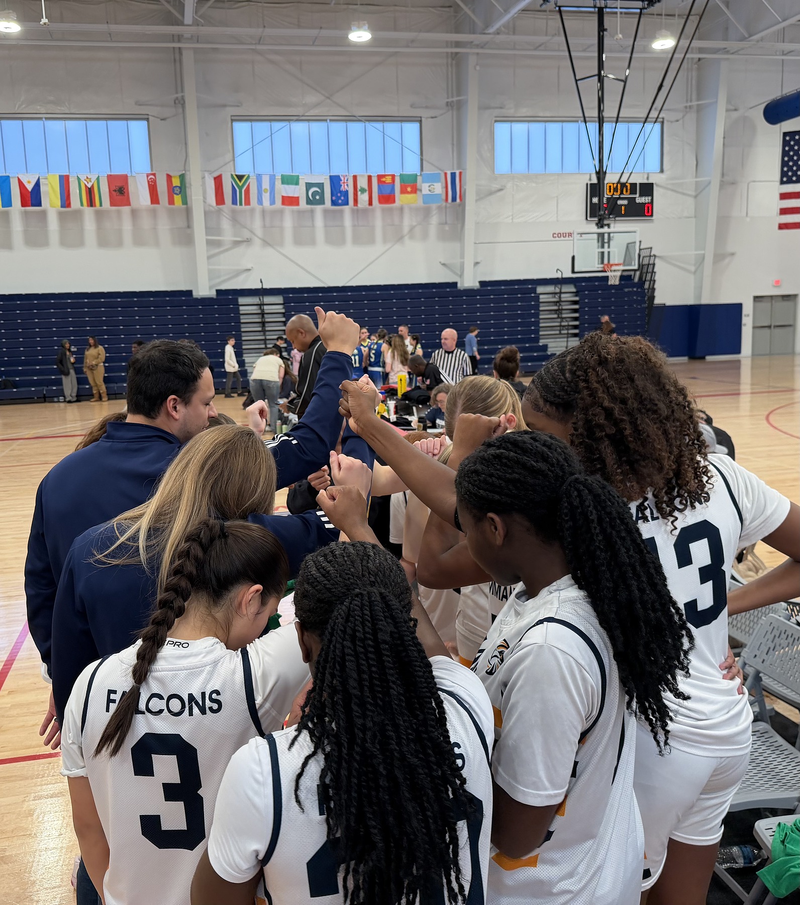 Coach Adrian Torres huddled with the Emmanuel Christian Academy Falcons girls basketball team